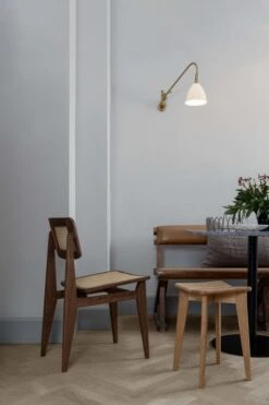 GUBI C-Chair, Cane - Oiled Walnut 12 GUBI C-Chair, Cane - Oiled Walnut -Gubi C ChairDiningChair TrefleStool BL6WallLamp GUBI1 0DiningTable On